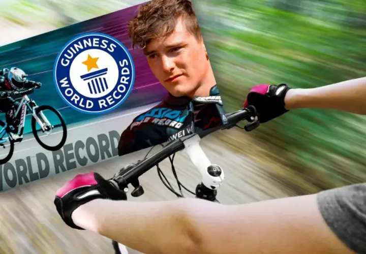 Kolarz w rękawiczkach i kasku pędzi na rowerze, celując w rekord prędkości na rowerze. Obok logo Guinness World Records.