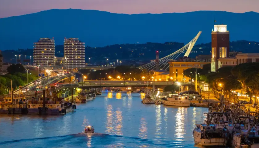 Wieczorem w Pescara: port z łodziami, nowoczesne budynki, most i wieża zegarowa. Warto zobaczyć!
