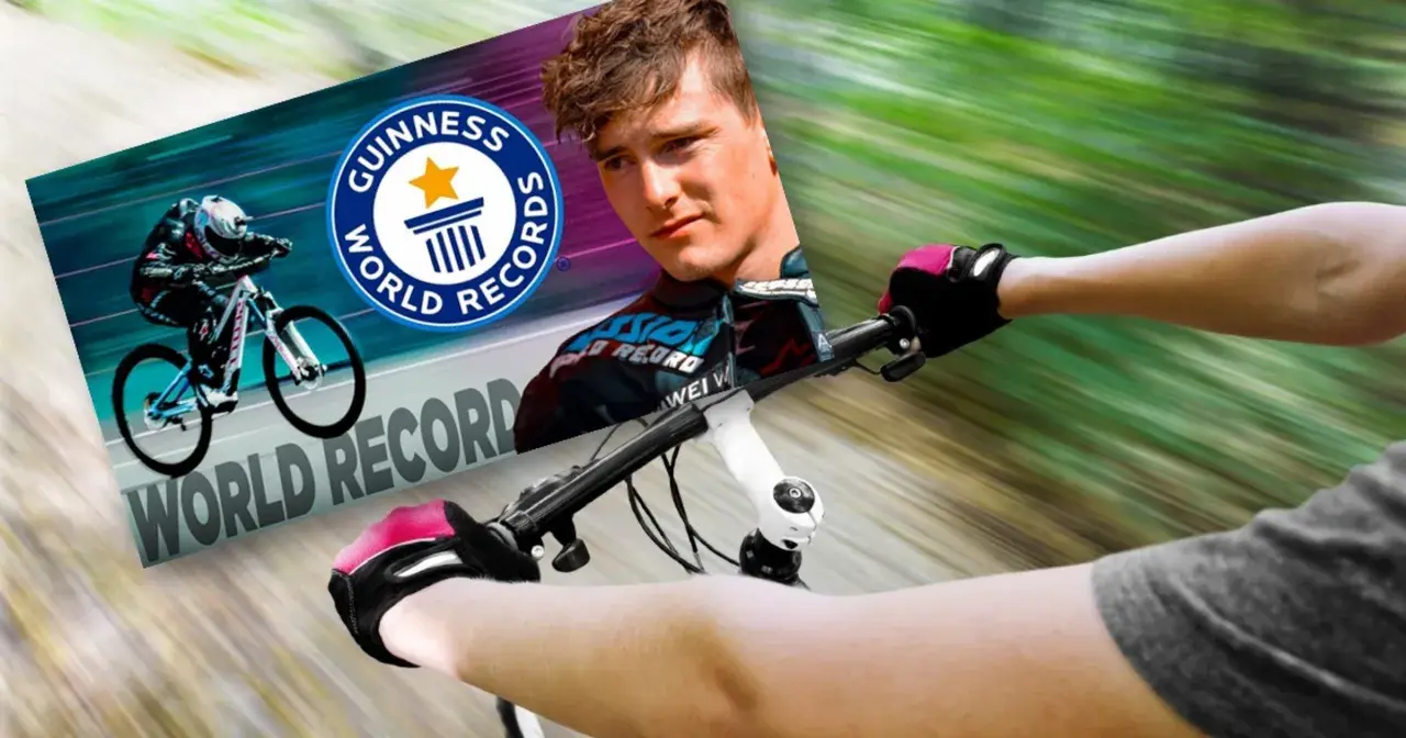 Kolarz w rękawiczkach i kasku pędzi na rowerze, celując w rekord prędkości na rowerze. Obok logo Guinness World Records.