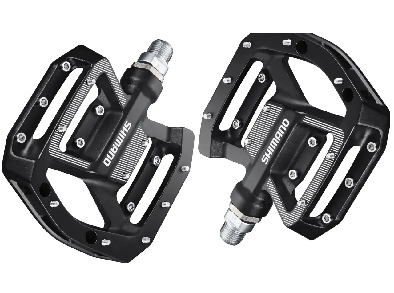 Czarne pedały platformowe Shimano z pinami, idealne do roweru gravelowego. Solidne i przyczepne, zapewniające pewność na każdej trasie.
